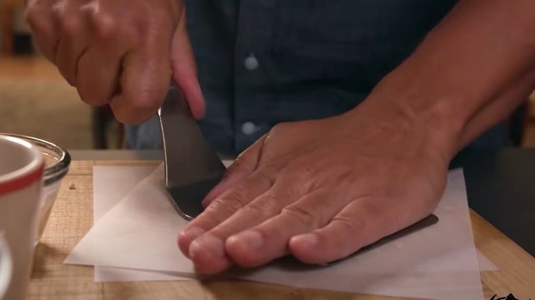 Smashing a hamburger with a spatula