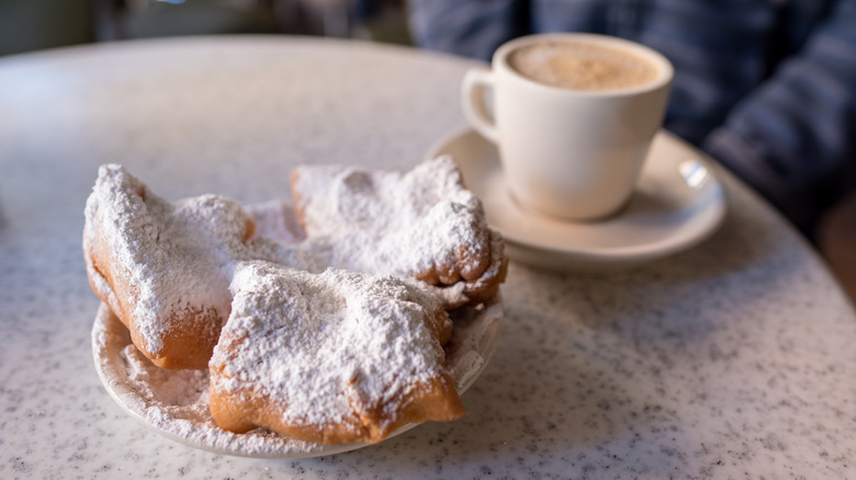 three beignets with coffee