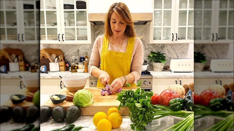 Camilla Marcus chopping in kitchen