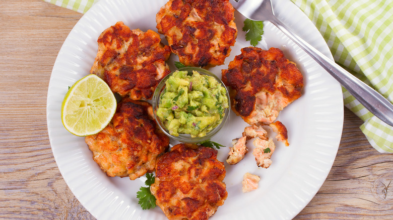 close up of sauteed salmon cakes and chunky guacamole 