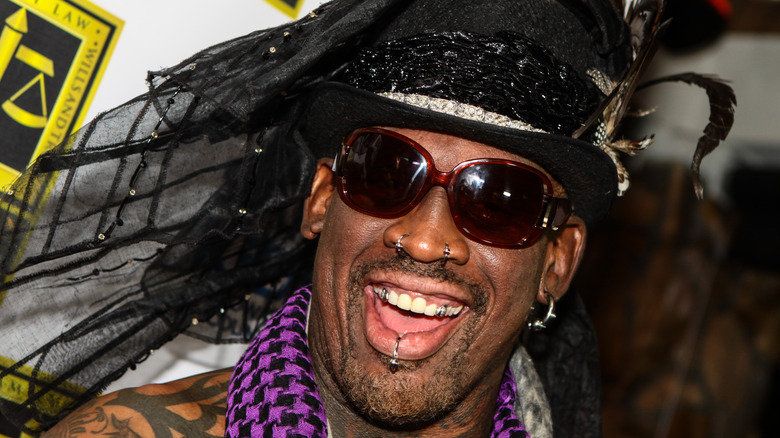 Dennis Rodman smiling in hat