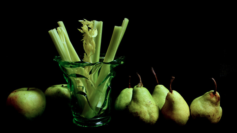 celery in a vase with pears