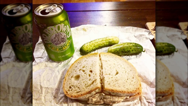 can of cel-ray with sandwich and pickle