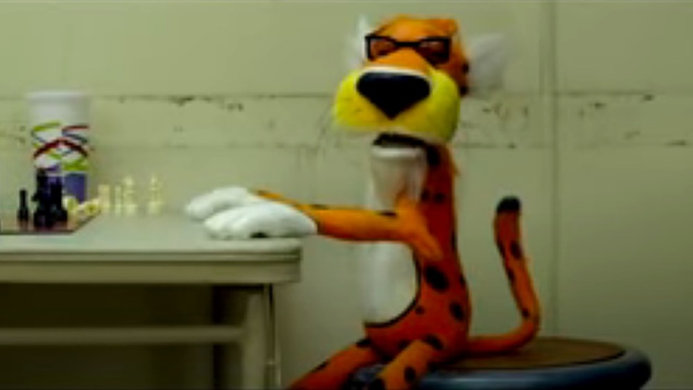 Chester Cheetah sitting on stool