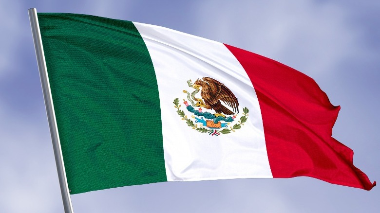 Mexican flag flying blue sky