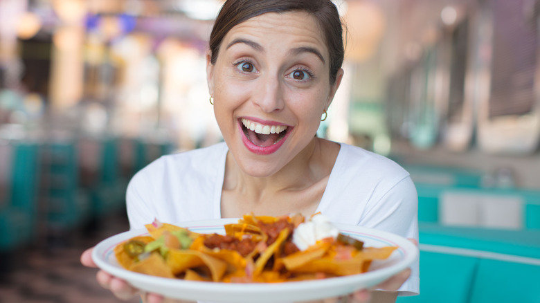 woman happy nachos