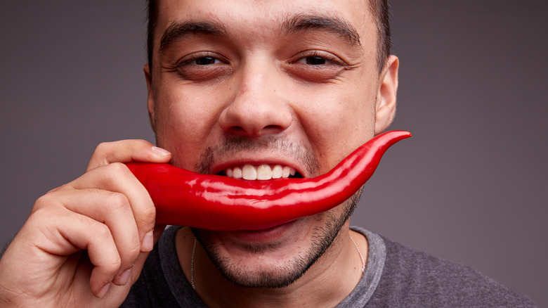 man chili pepper eat