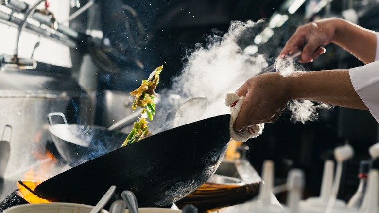 stir fry pan vegetables flying