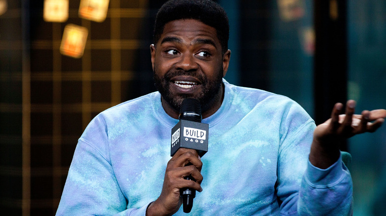 Ron Funches speaking into microphone