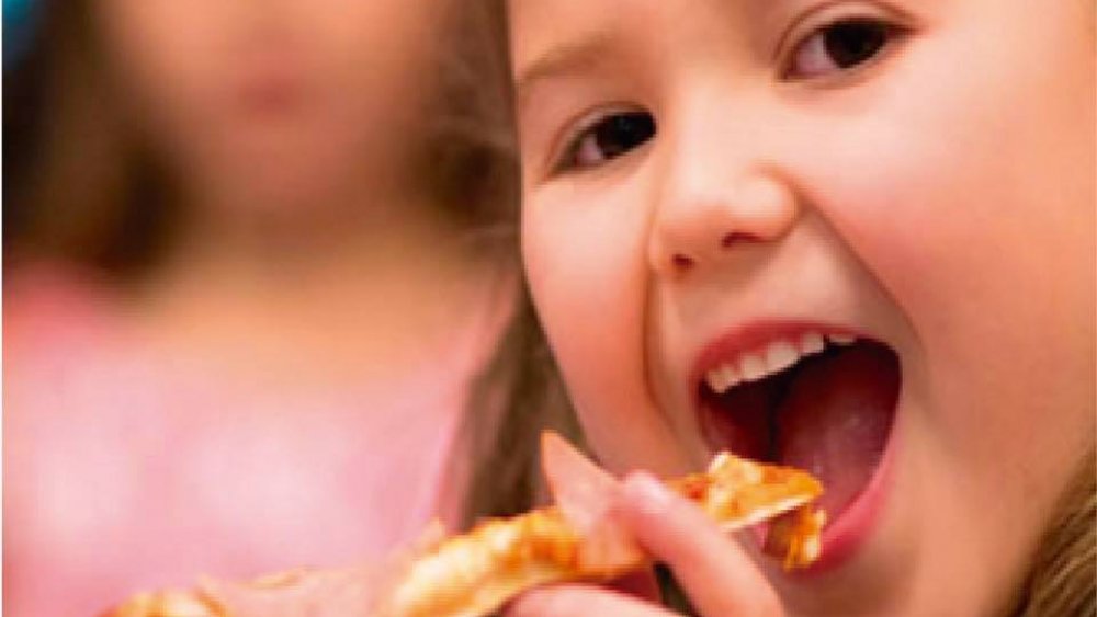 Girl eating Chuck E. Cheese pizza