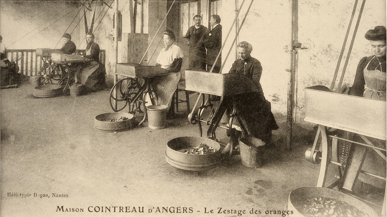 Employees peeling oranges c.a.1900s