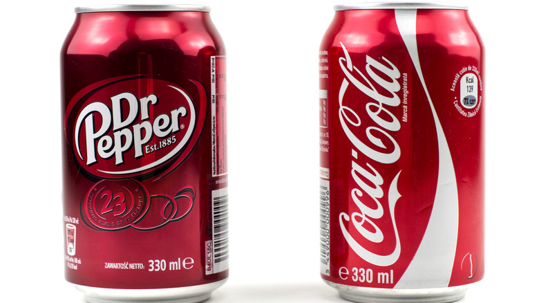Dr. Pepper can next to Coke can