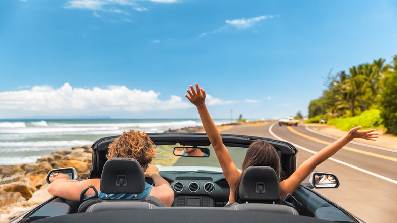 couple driving in convertible