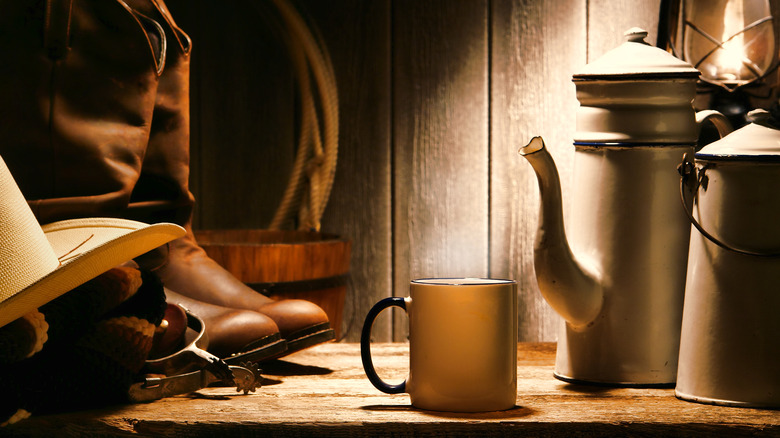 Tin coffee pot and mug with cowboy boots