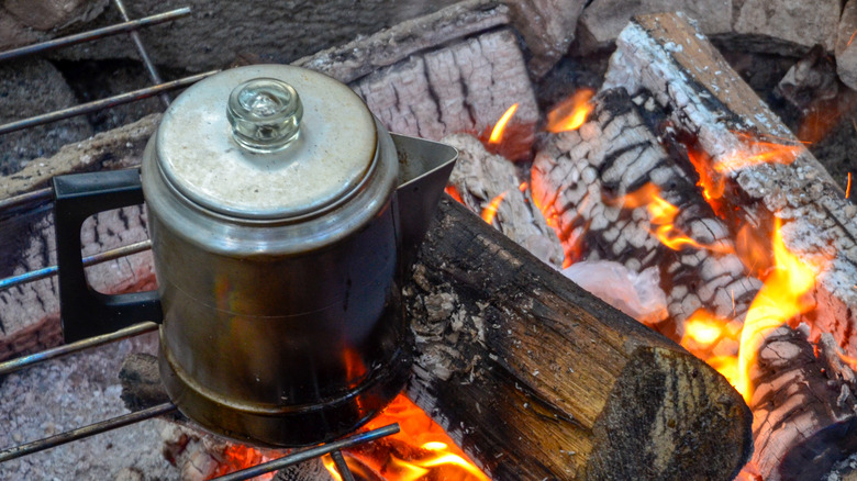 Tin coffee pot by open fire