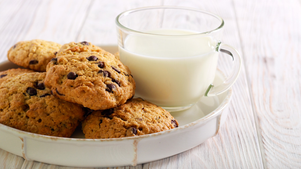 cowboys cookies on a plate with a glass of milk