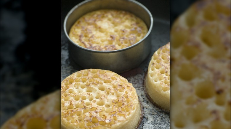 crumpets sizzling on a pan