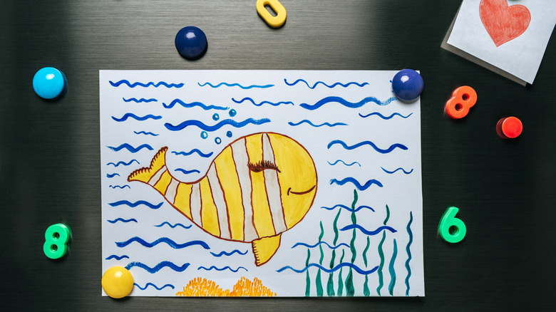 Fish drawing and magnets on refrigerator