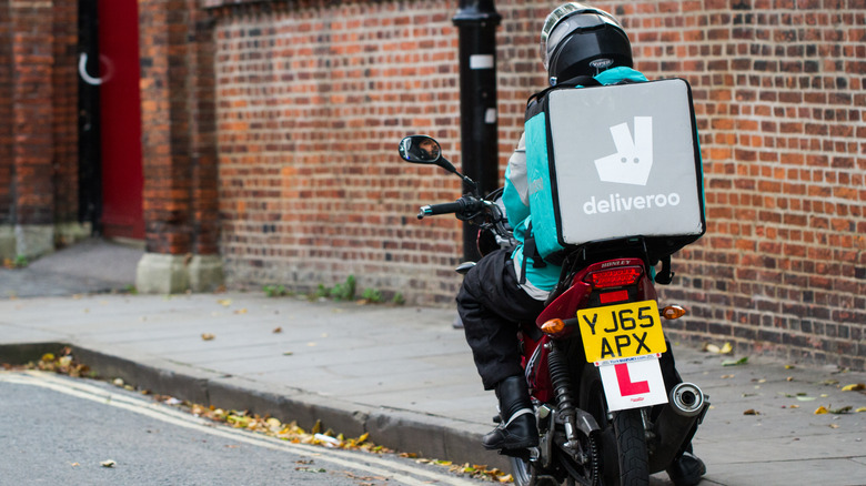 Deliveroo delivery driver on motorcycle