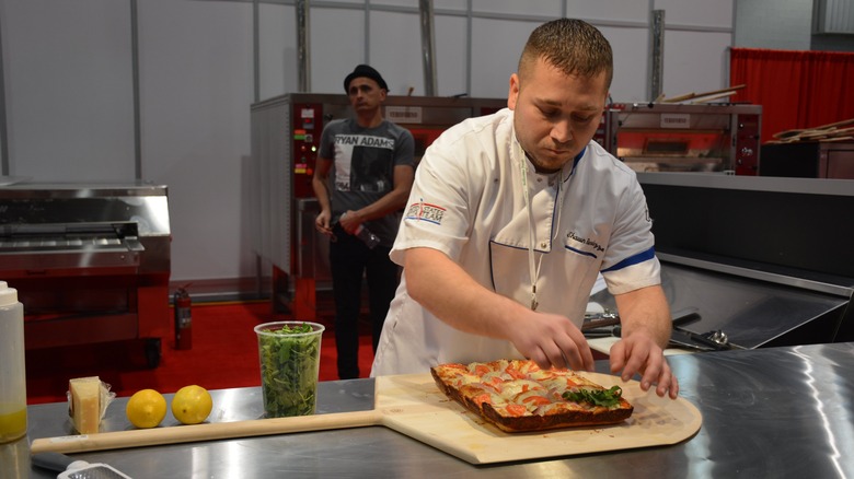 Chef preparing a pizza in a competition