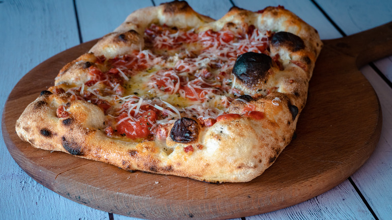 Sicilian pizza on wood block