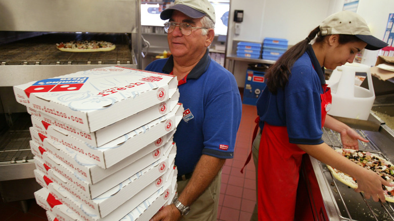 Man holding pizza boxes