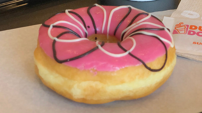 Strawberry frosted donut on tray