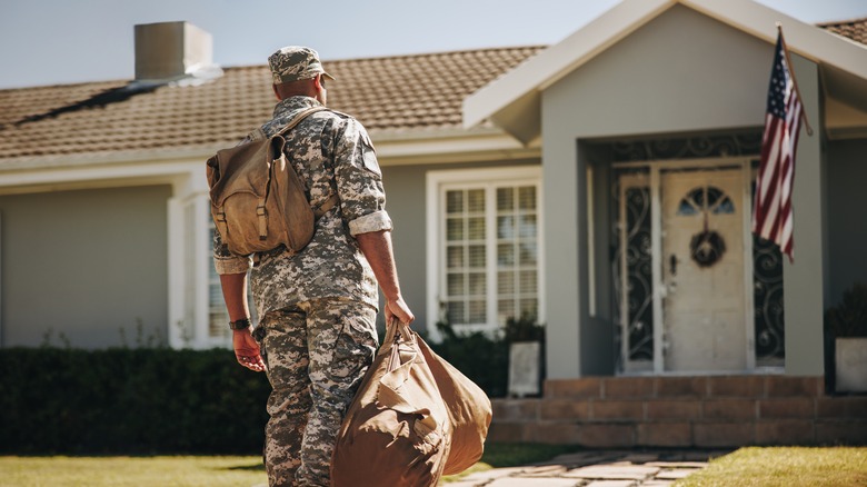 Soldier standing outside home