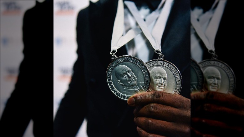 Two James Beard medals around neck