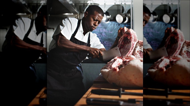 Edouardo Jordan butchering meat