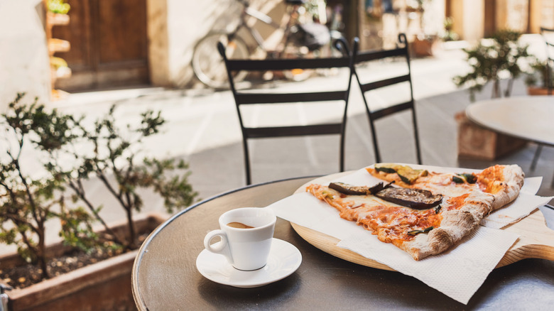espresso and pizza on table