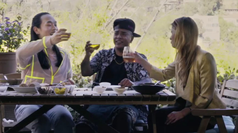 People cheersing at picnic table