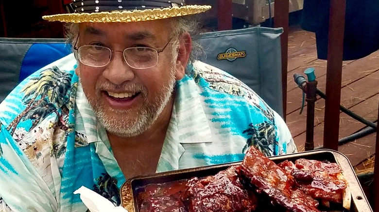 Barbecue ribs smoking on a two-tiered grill 