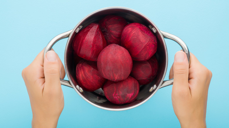 Hands holding boiled beets