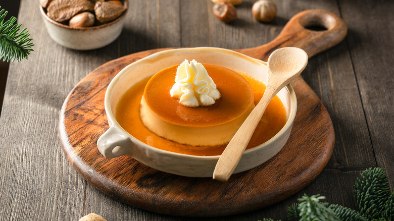 Caramel flan on wooden serving tray