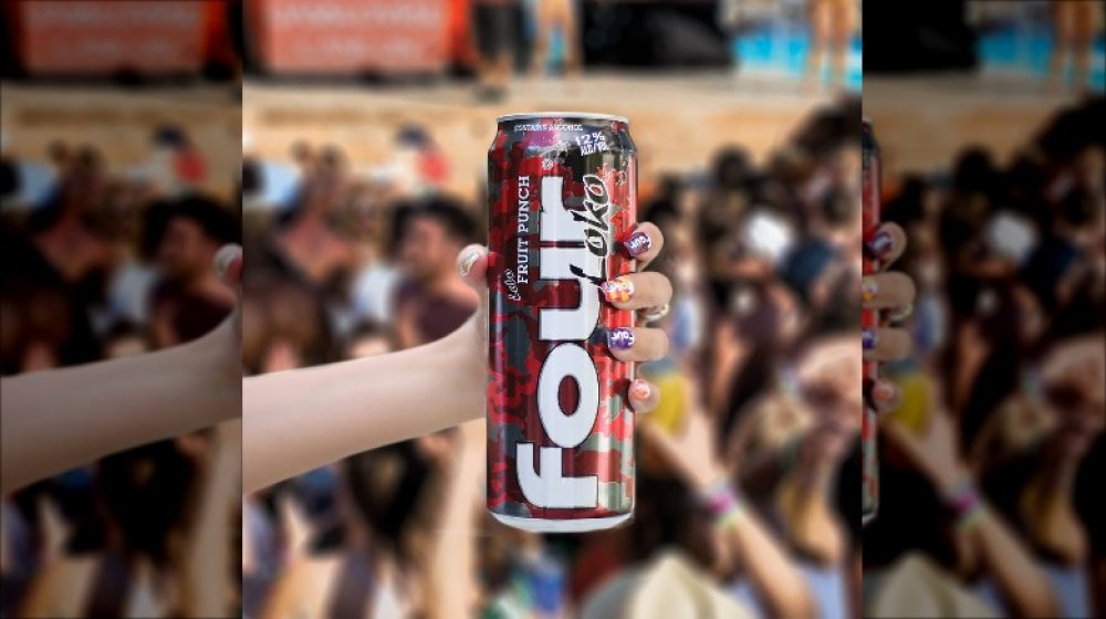 hand with nail art holding four loko can