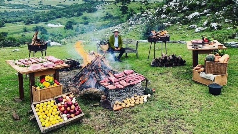 Francis Mallmann surrounded by food