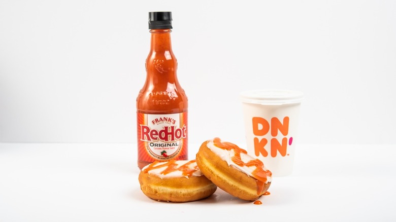 Frank's flavored donuts, a bottle of franks, and a Dunkin' Coffee