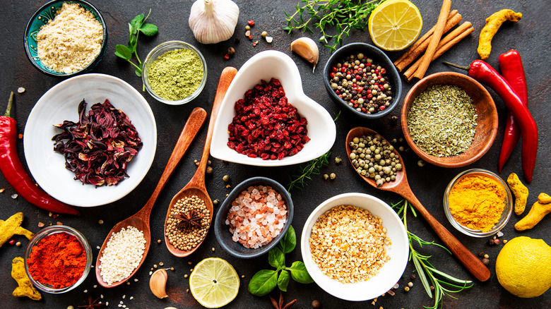 herbs and spices in different shaped bowls