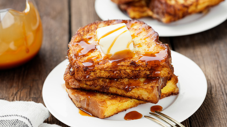 stack of french toast with butter and caramel 