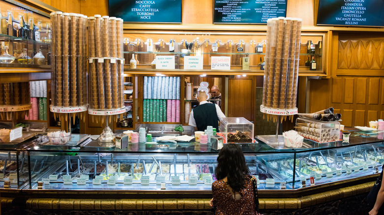 woman standing at gelato counter