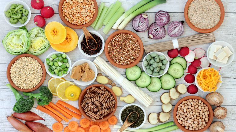 Array of healthy veggies and nuts on table