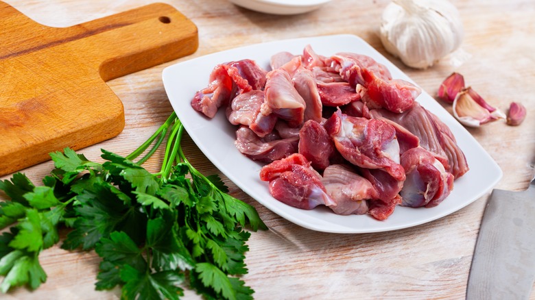 Raw gizzards on white plate