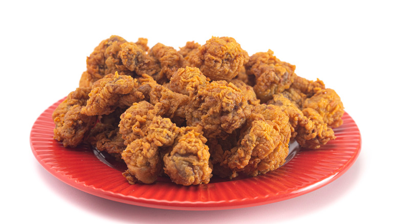 Fried gizzards on red plate