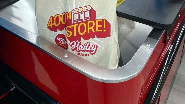 Grocery Outlet 400th store canvas bag on checkout counter