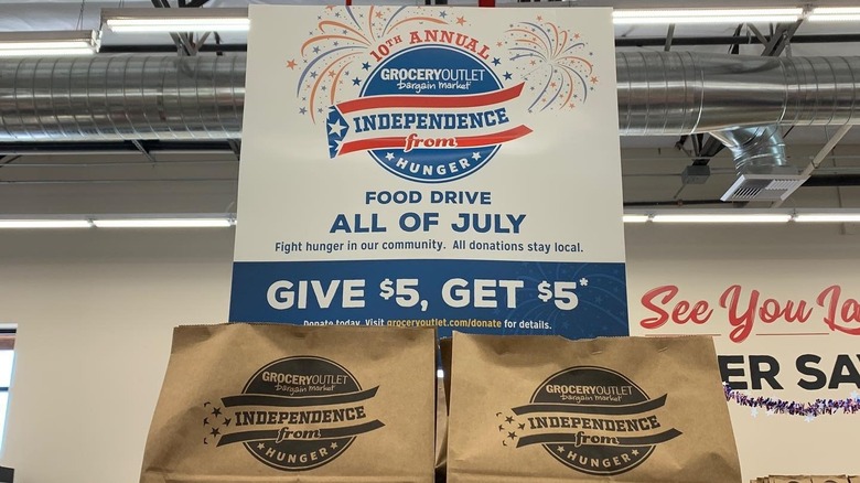 Grocery Outlet Independence from Hunger food drive sign and prefilled grocery bags