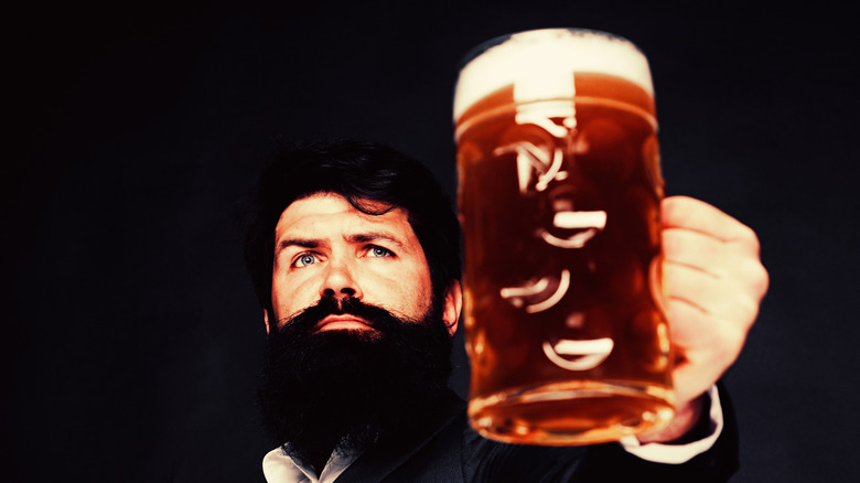 Man with beard holding a pint