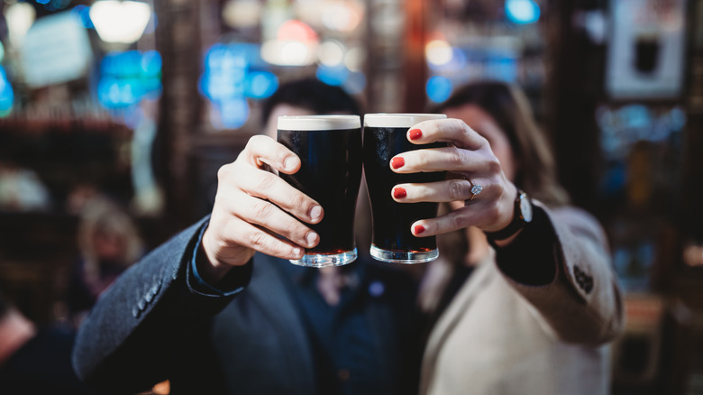 Man and woman drinking Guinness