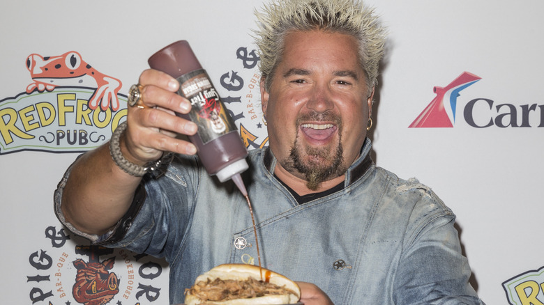 Guy Fieri and a bottle of sauce