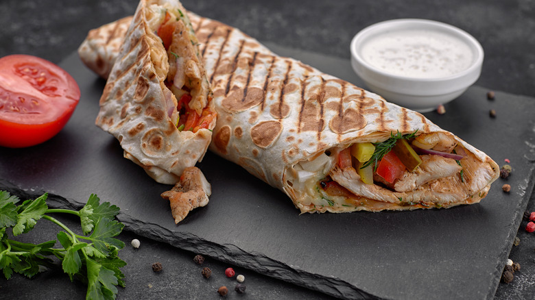 A shawarma wrapped in bread and filled with veggies